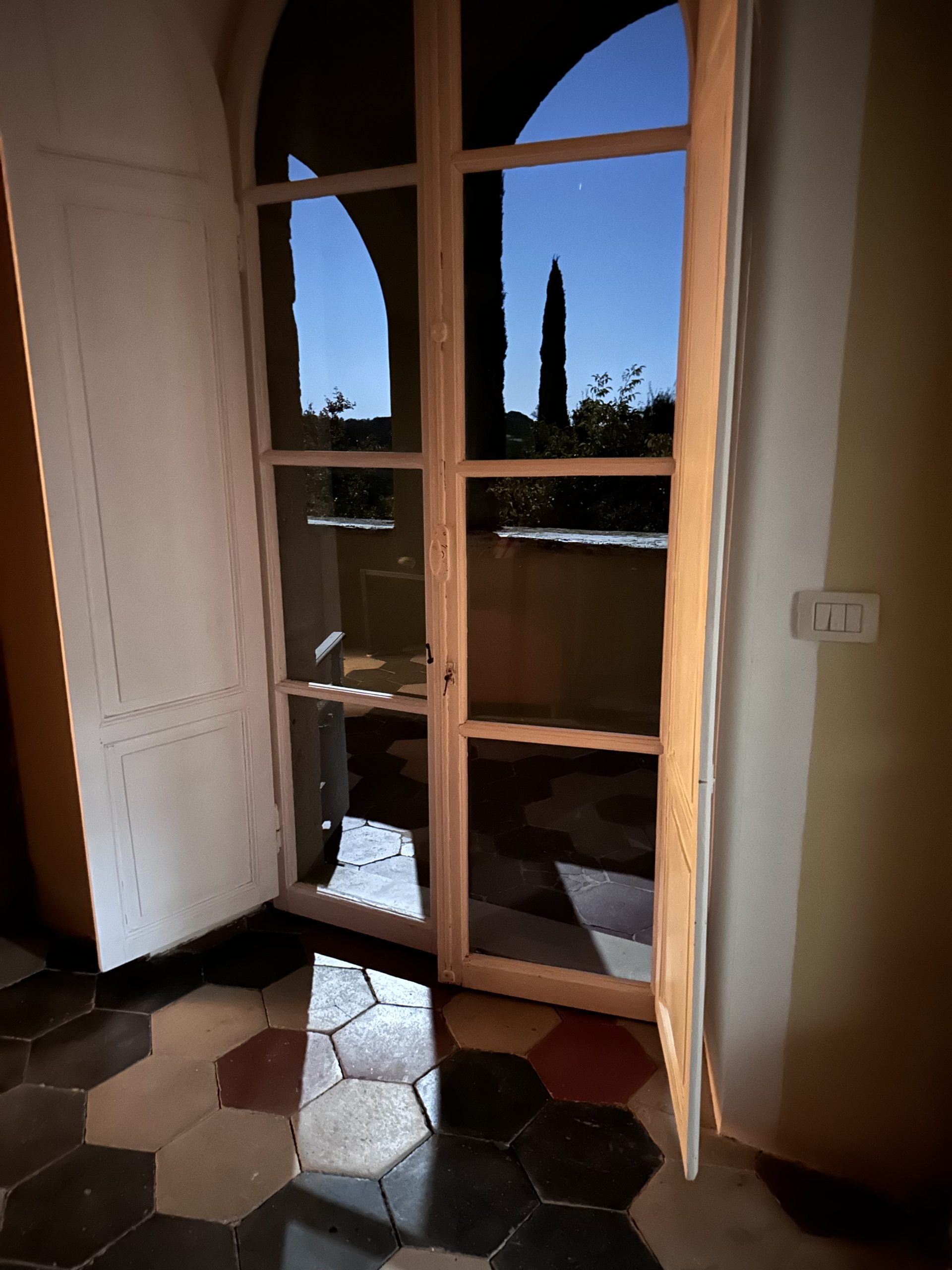 Moonlight falls through the doors at the villa